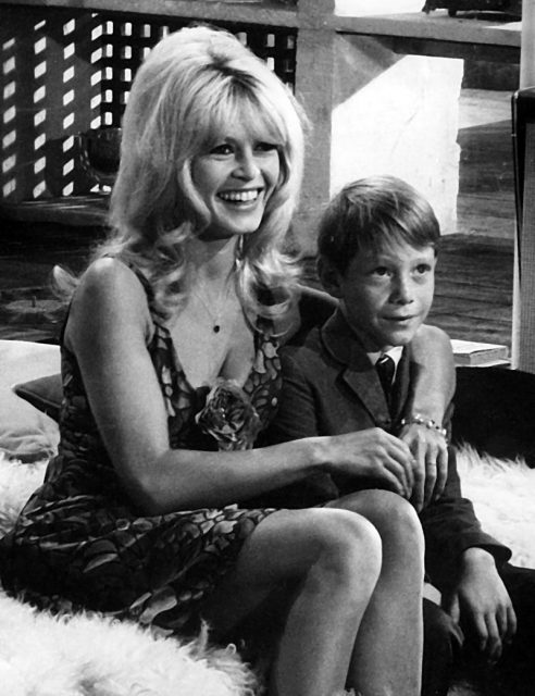 Publicity photo of Brigitte Bardot and Billy Mumy on set of Dear Brigitte (1965).