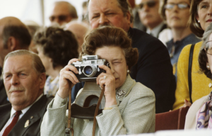 the Queen holding a camera