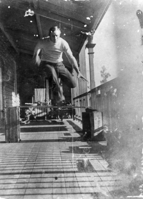Roller skating on the veranda, 1909. Jumping over a wooden bar.