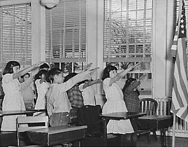 Children performing the Bellamy salute to the flag of the United States, 1941.
