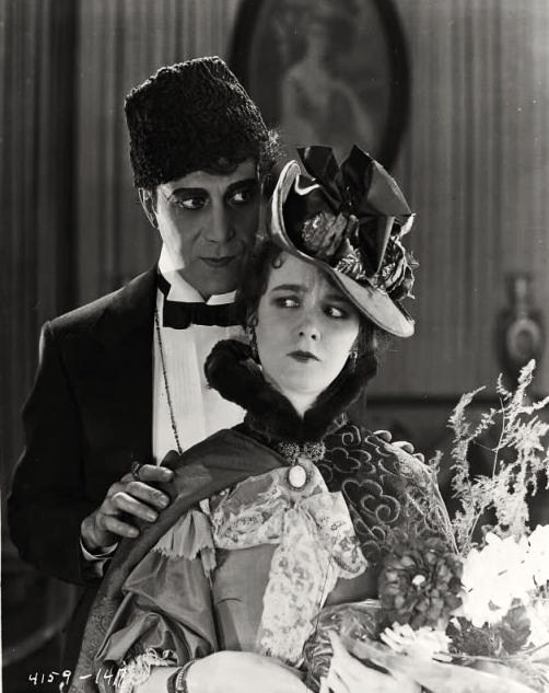 Arthur Edmund Carewe & Mary Philbin in The Phantom of the Opera – publicity still (original image damaged, modified & cropped).