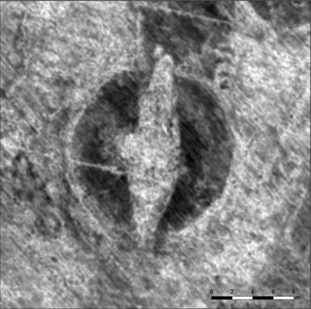 The outlines of a Viking ship within a burial mound. Photo by NIKU