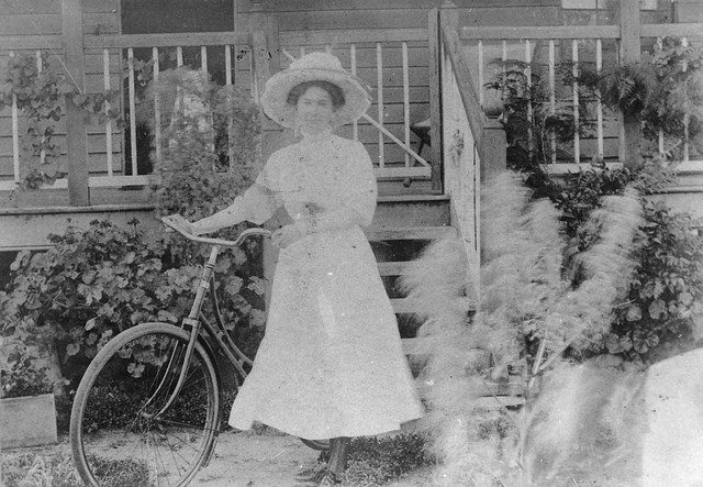 Woman with bicycle, c. 1908