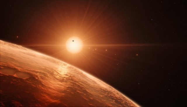 This artist’s impression shows the view from the surface of one of the planets in the TRAPPIST-1 system. At least seven planets orbit this ultra cool dwarf star 40 light-years from Earth and they are all roughly the same size as the Earth. Photo by ESO/M. Kornmesser CC BY SA 4.0