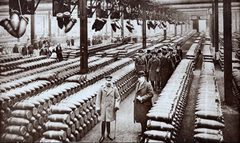 King George V (front left) and a group of officials inspect a British munitions factory in 1917
