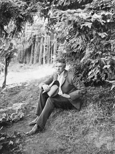 Ambrose Bierce sitting outside