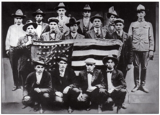 Trainee Choctaw Code Talkers standing with the American flag