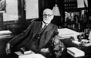 Sigmund Freud sitting at his desk
