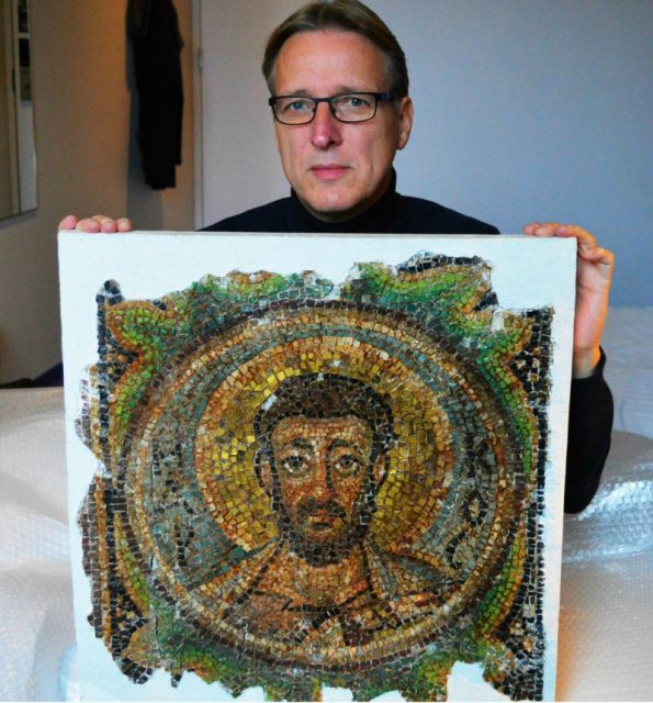 Dutch art detective Arthur Brand poses with the missing mosaic of St Mark, a rare piece of stolen Byzantine art from Cyprus, in a hotel room in The Hague on November 17, 2018. – Brand said he handed back the artwork to Cypriot authorities on the same day. (Photo by Jan HENNOP / AFP) (Photo credit should read JAN HENNOP/AFP/Getty Images)