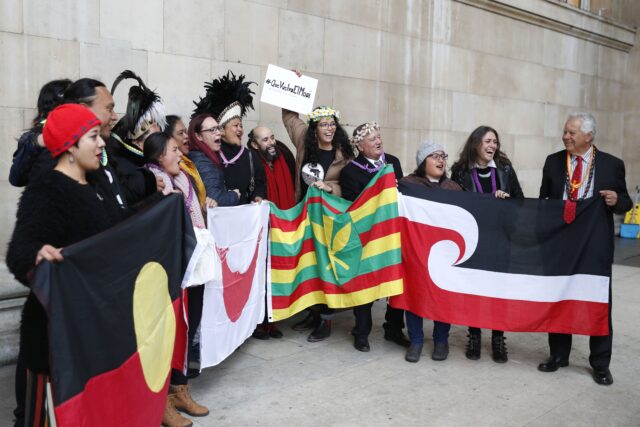 A group of demonstrators holding flags.