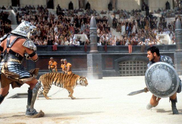 Russell Crowe facing off against tiger in a scene from the film Gladiator (2000). Photo by Universal/Getty Images
