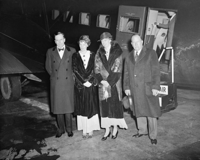 Mrs. Franklin D. Roosevelt and Mrs. Amelia Earhart Putnam, prominent aviatrix, went up for a night sky ride in Washington, D.C., on April 20th, and during the flight Mrs. Roosevelt took over the controls of the plane, breaking another precedent. This photo shows the group after the flight. Left to right: George Palmer Putnam, Mrs. Amelia Earhart Putnam, Mrs. Roosevelt, and Captain Doe, president of the Easter Air Transport.
