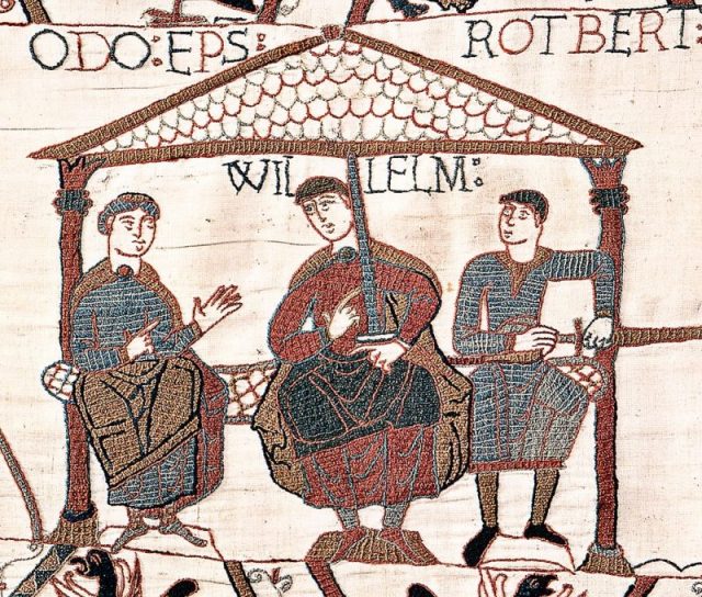 Image from the Bayeux Tapestry showing William with his half-brothers. William is in the centre, Odo is on the left with empty hands, and Robert is on the right with a sword in his hand.