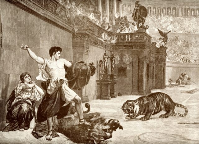 Vintage engraving showing a man saving a woman from a lion and tiger in the Roman Arena.