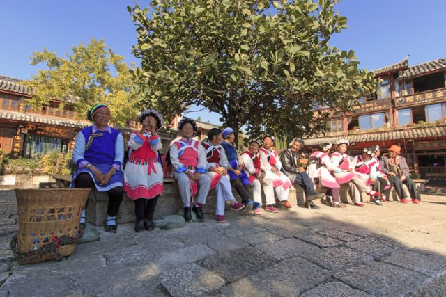 Lijiang, China – November 10, 2016: Old women dressed with the traditional attire of their minority in Lijiang Old Town.