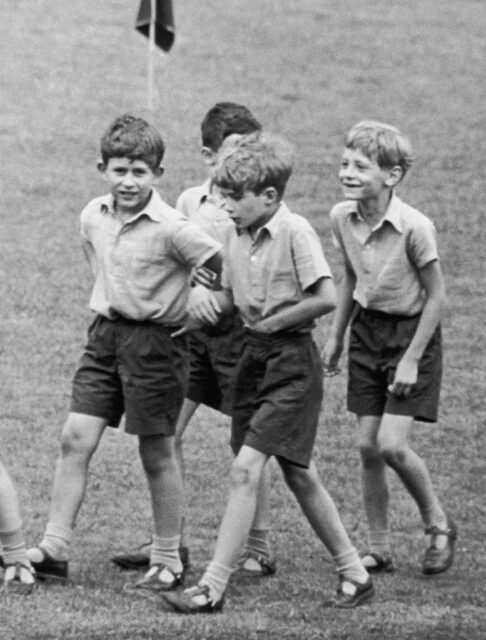 Then-Prince Charles walking with three boys