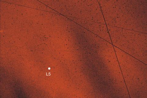 Pattern of the angle of polarization of the sky around the L5 Lagrange point of the Earth-Moon system, measured by imaging polarimetry in the green (550 nm) spectral range at 01:14:15 UT on 19 August 2017. The position of the L5 point is shown by a white dot. In this picture the central region of the Kordylewski dust cloud is visible (bright red pixels). The straight tilted lines are traces of satellites. Photo Courtesy J. Slíz-Balogh