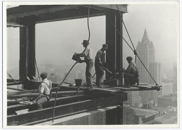 Riveters attaching a beam.