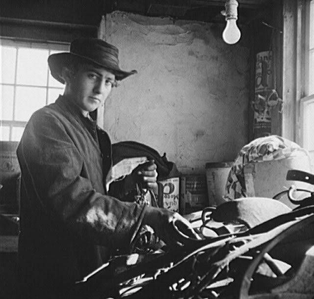 This beardless unmarried man, not yet a member of the church, may have posed for this photograph while he was working in the barn. March, 1942