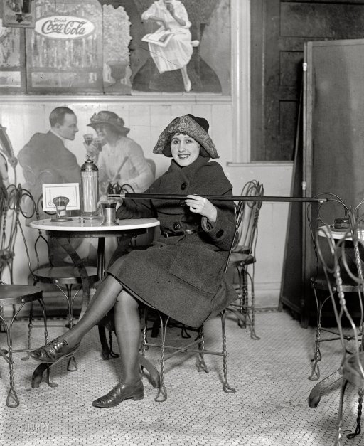 February 13, 1922. Washington, D.C. Unidentified woman holding a “tipping cane” also known as a “cane flask” during Prohibition.