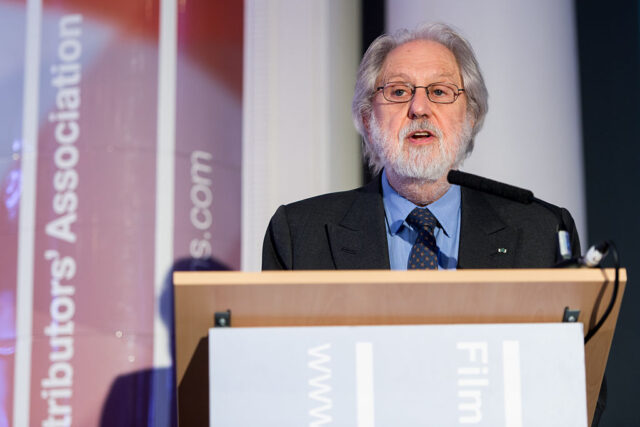 David Puttnam speaking at a podium