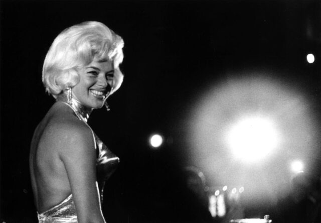 Diana Dors standing on stage