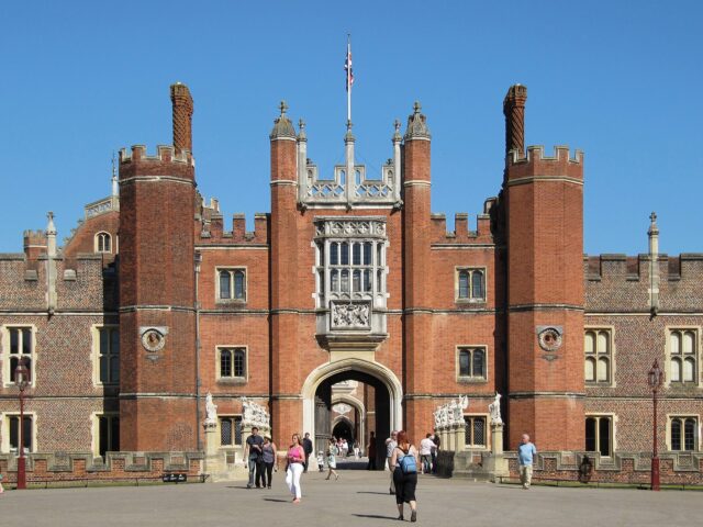 People walking through the Great Gate at Hampton Court Palace