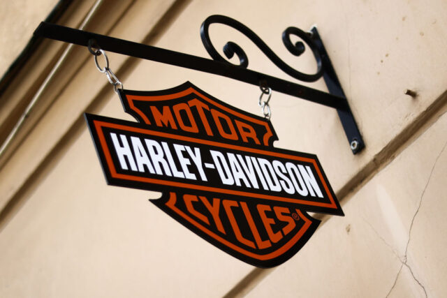 Harley-Davidson sign hanging on the outside of a building