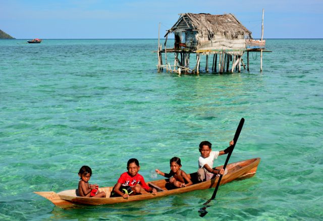 Semporna, Sabah, Malaysia – April 19, 2015 : paddle a canoe (Lepa-lepa) at a Bajau floating Village in Maiga Island Semporna, Sabah Borneo, Malaysia. They live in house boats or stilt houses built on top of coral reefs.