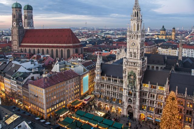 Town hall and frauenkirche Munich, Germany, panoramic view of two famous landmarks with Christmas decoration during sunset.