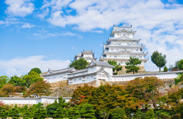 Himeji, Japan – October 24th, 2014: Autumn had arrived to Himeji-jo Castle. Himeji Castle is a hilltop Japanese castle complex located in Himeji, in Hy?go Prefecture, Japan. The castle is regarded as the finest surviving example of prototypical Japanese castle architecture, comprising a network of 83 buildings with advanced defensive systems from the feudal period.