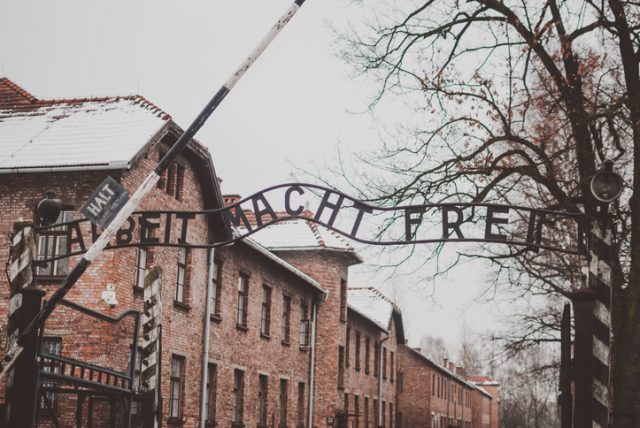 Oswiecim, Poland – February 16, 2018: The famous arch of the concentration camp Auschwitz. Inscription: Arbeit macht frei (work sets you free).