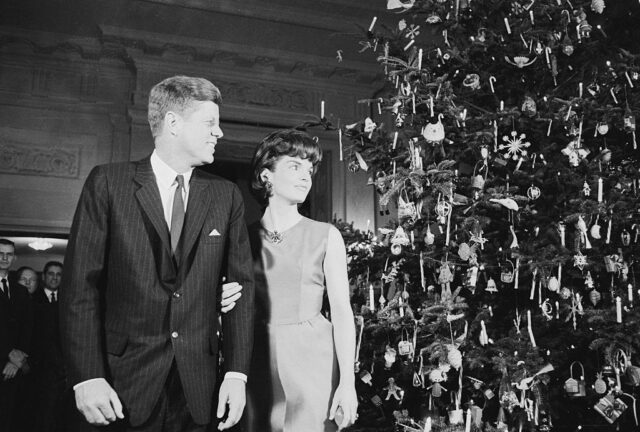 John F. and Jacqueline Kennedy staring at a Christmas tree