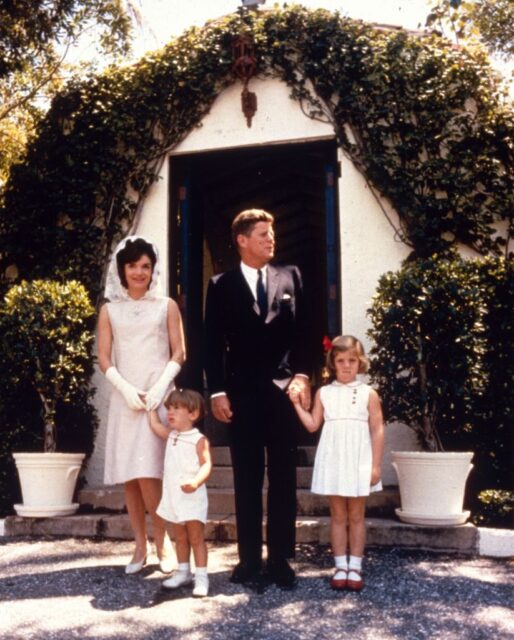Kennedy family standing together at the entrance of a building