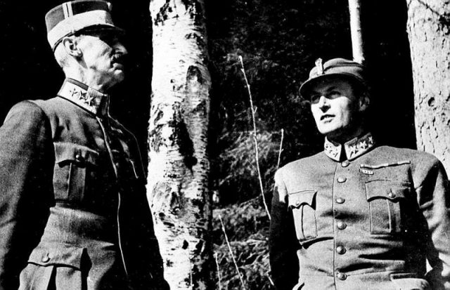 King Haakon VII and Crown Prince Olav seeking shelter on the outskirts of Molde during a German bombing raid on the city in April 1940.