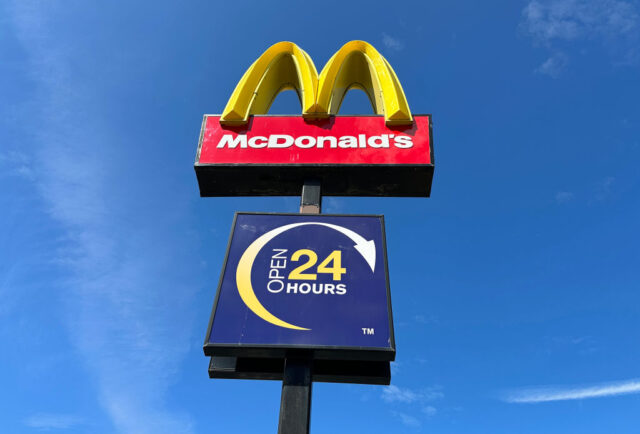 McDonald's sign with another at the bottom indicating the restaurant is open 24 hours