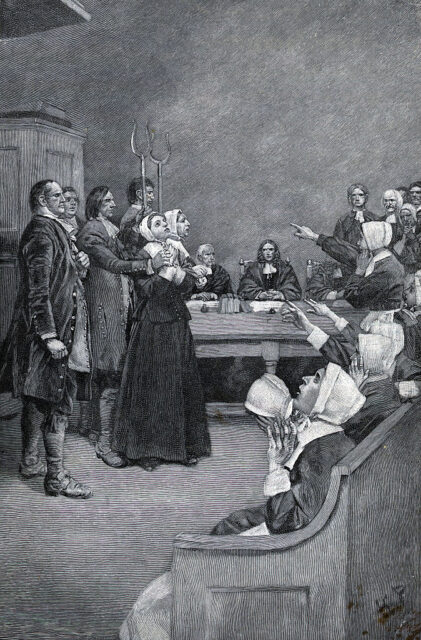 Illustration of accused female witches standing in the middle of a courtroom