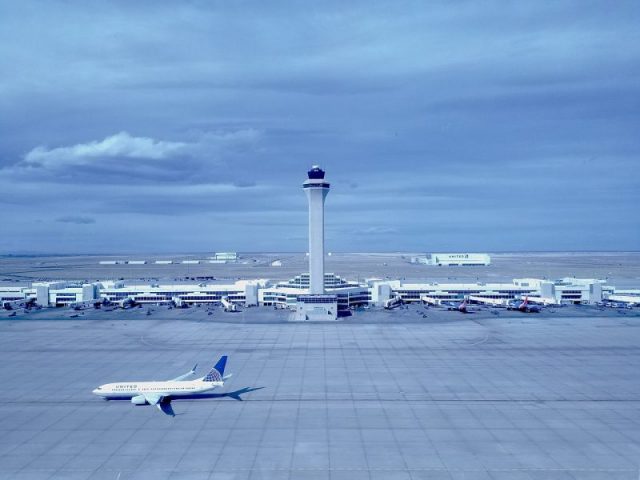 The Air Traffic Control Tower at Denver International Airport with a United Airlines Boeing 737-800 below. Photo by Bmurphy380 CC BY-SA 4.0