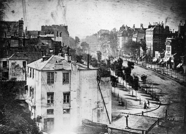 “Boulevard du Temple” taken by Daguerre in 1838 in Paris includes the earliest known candid photograph of a person.