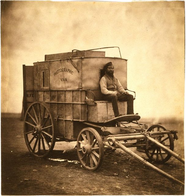 Roger Fenton’s assistant seated on Fenton’s photographic van, Crimea, 1855.