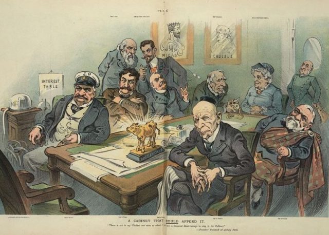 Illustration shows eight men and one woman sitting and standing around a table, each is identified with a Cabinet position: J.P. Morgan as “Sec’y Navy”, Thomas W. Lawson as “Sec’y War”, Thomas F. Ryan as “Att’y Gen’l”, James J. Hill as “Sec’y Int.”, James H. Hyde as “Sec’y Com. and Lab.”, Russell Sage as “Sec’y Agric”, Henrietta “Hetty” Green as “Post Mistress Gen’l”, Andrew Carnegie as “Sec’y State”, and John D. Rockefeller as “Sec’y Treas.”