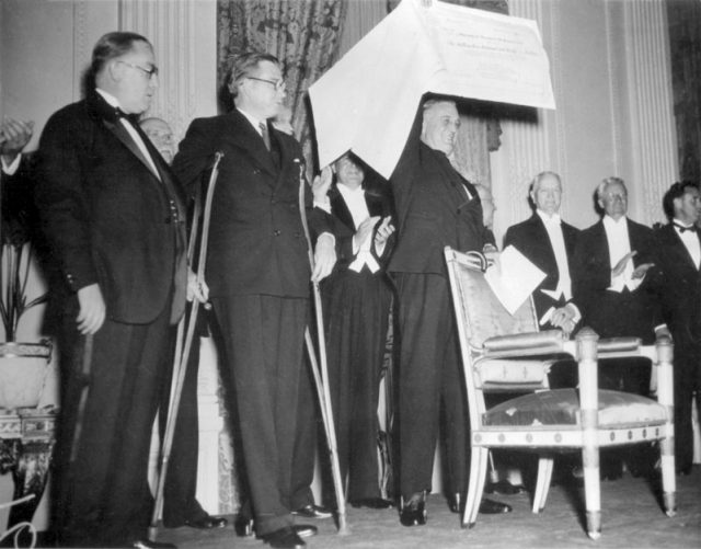 FDR receives a $1 million check, proceeds from the first President’s Birthday Ball (1934).