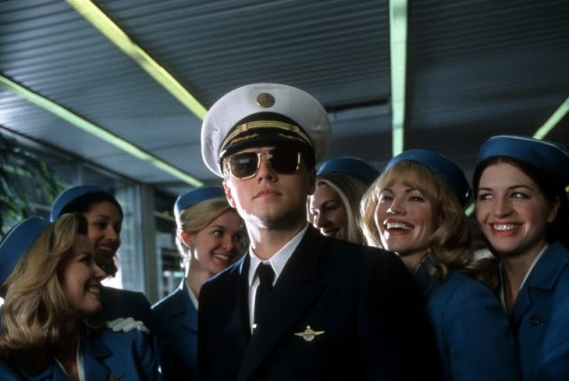 Leonardo DiCaprio with airline stewardess surrounding him in a scene from the film ‘Catch Me If You Can’ (2002). Photo by DreamWorks SKG/Getty Images