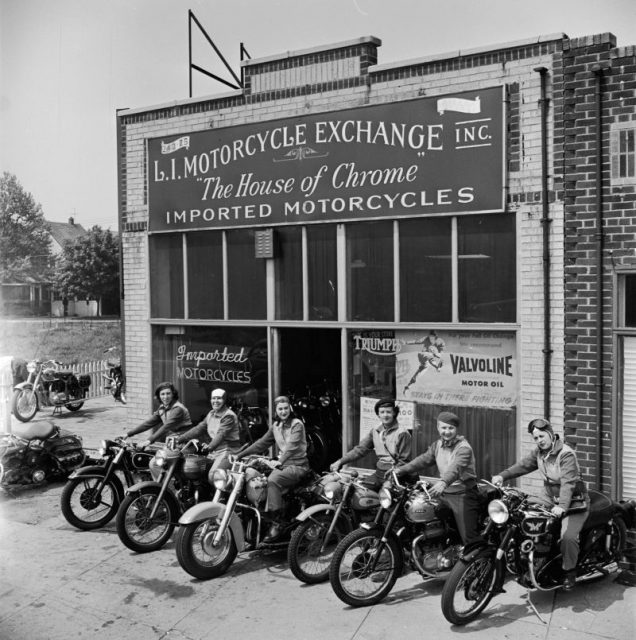 A group of women dubbed the ‘Motor Maids of America’ sit astride their motorcycles outside the shop they use as their headquarters. (Photo by Douglas Grundy/Three Lions/Getty Images)