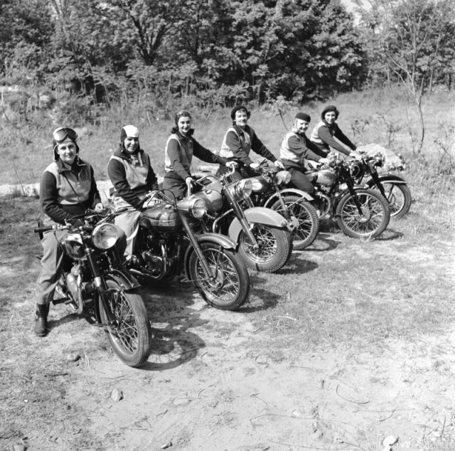A group of women dubbed the ‘Motor Maids of America’ sit astride their motorcycles. (Photo by Douglas Grundy/Three Lions/Getty Images)