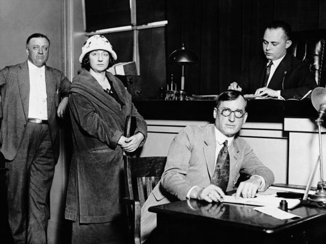 Mrs. Walburga Oesterreich being arraigned in court on the alleged charges of murdering her husband. Left to right: Detective Cline, Mrs. Oesterreich, Judge Channing Follette, and a court reporter.