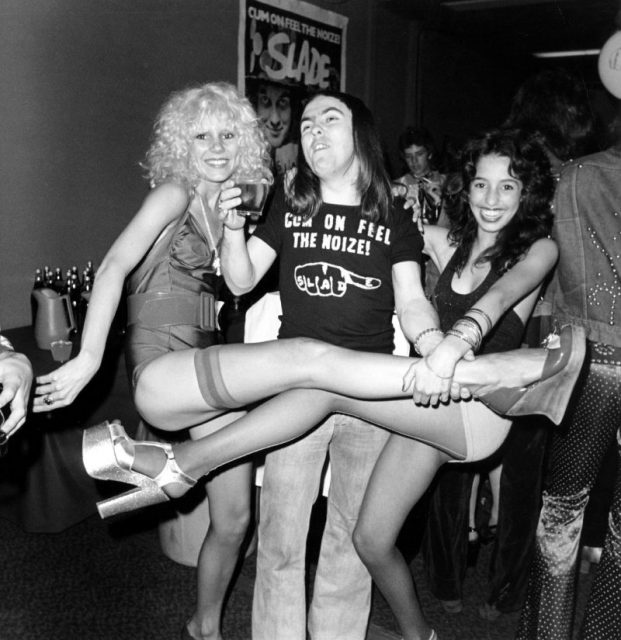 Groupie Sable Starr, guitarist in the rock and roll band Slade Dave Hill and groupie Lori Maddox pose for a portrait in June 1973 in Los Angeles, California. Photo by Michael Ochs Archives/Getty Images