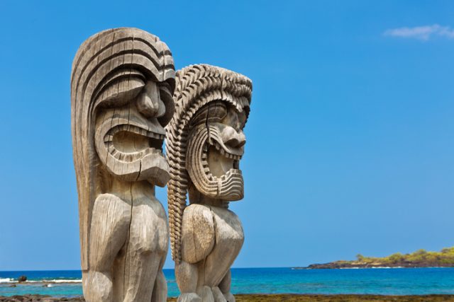 Pu’uhonua o Honaunau National Historical Park on the Big Island of Hawaii. The “Ki’i”, wooden images of the gods, stand on the shore of the historic park as guardians of the inhabitants of the historic village.