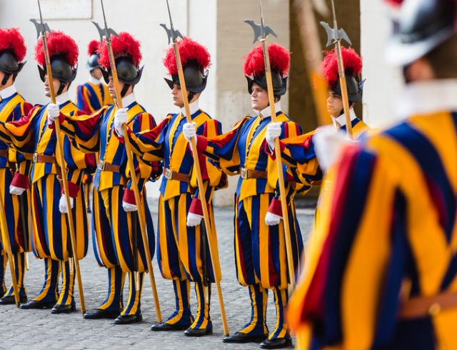 Vatican City: Papal Swiss Guard in uniform. Currently, the name Swiss Guard generally refers to the Pontifical Swiss Guard of the Holy See stationed at the Vatican in Rome.