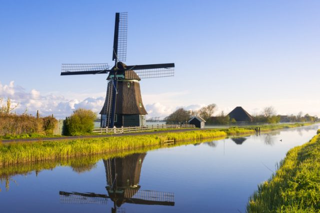 Dutch windmill beside a canal